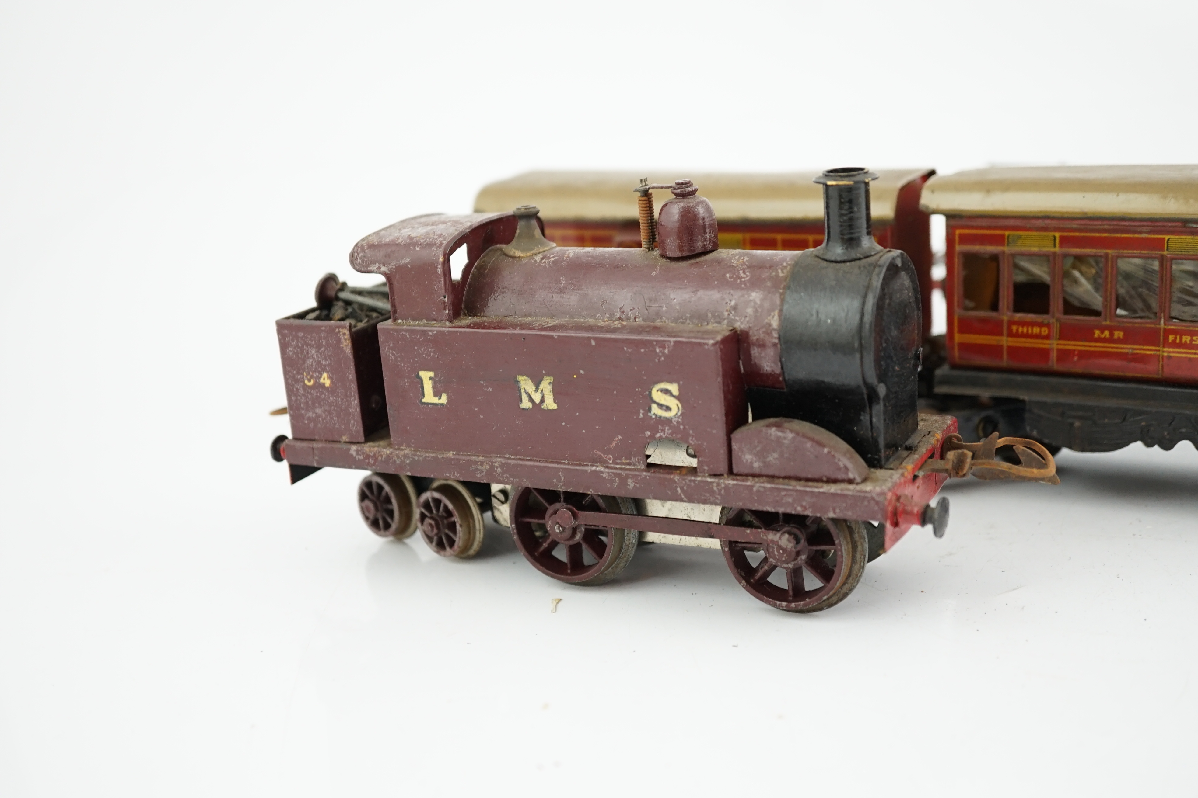Ten 0 gauge tinplate railway items, most adapted from other parts and models, including three clockwork locomotives; n LSWR 4-4-0 tender loco, an LMS 0-4-4T loco and an SR 0-4-2T loco, together with four SR 4-wheel coach